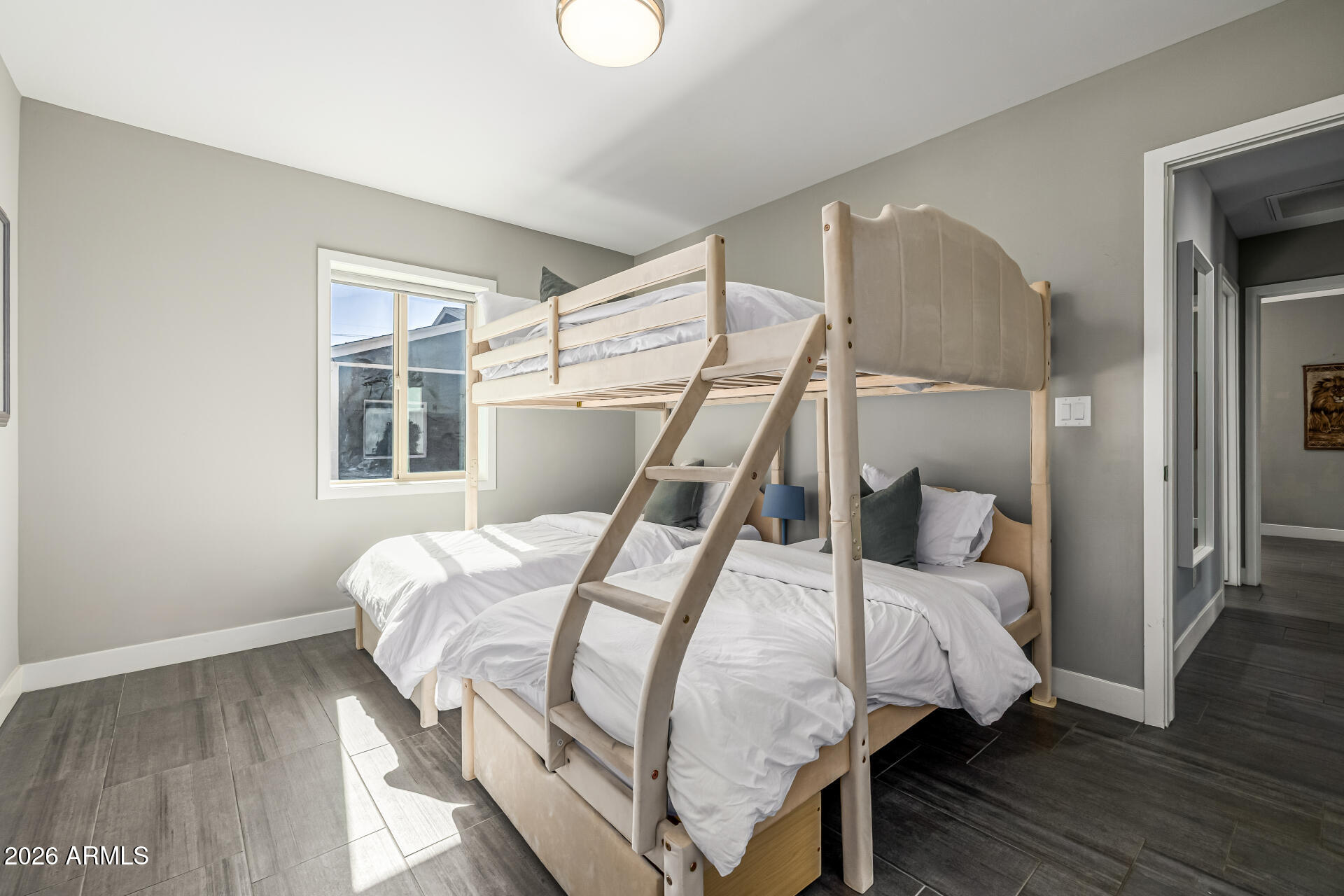 6726 North 11th Street Phoenix, AZ 85014 - Photo 29 of 49 a bedroom with a bed and wooden floor