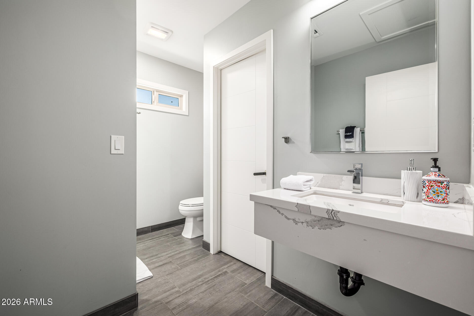 6726 North 11th Street Phoenix, AZ 85014 - Photo 38 of 49 a bathroom with a sink a toilet and a mirror