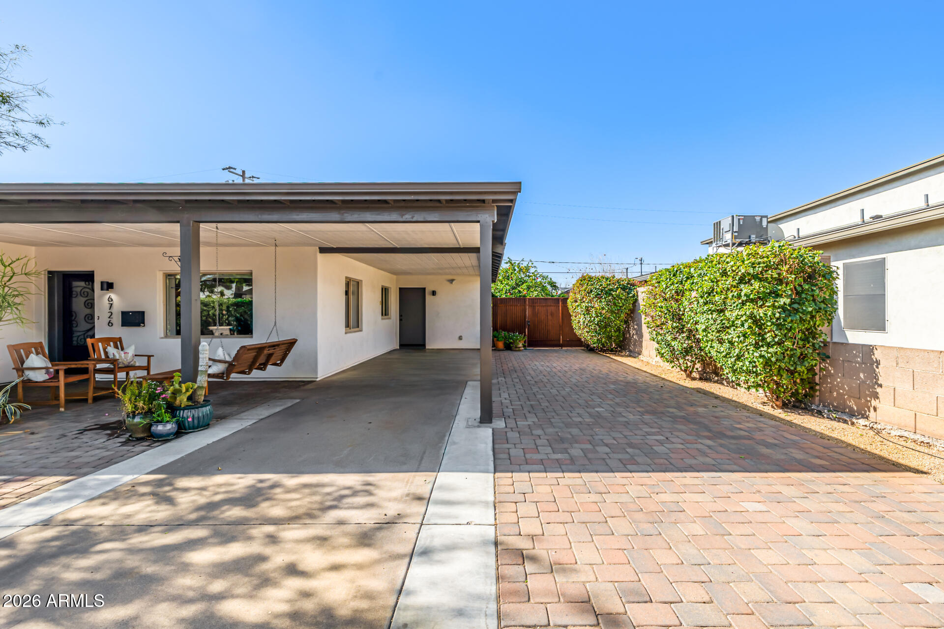 6726 North 11th Street Phoenix, AZ 85014 - Photo 4 of 49 a view of a house with potted plants in front of it