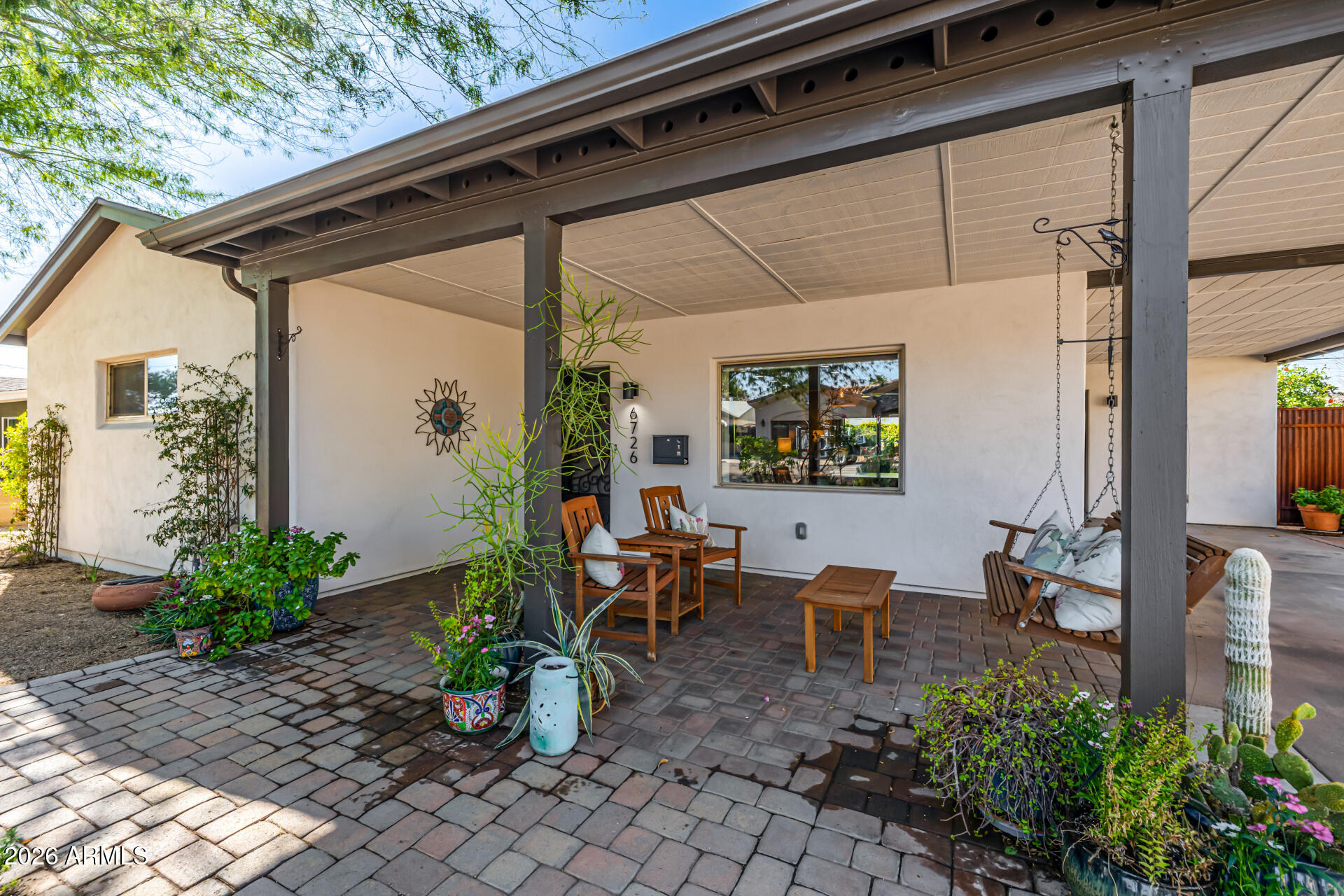 6726 North 11th Street Phoenix, AZ 85014 - Photo 6 of 49 a view of a porch with chairs and potted plants