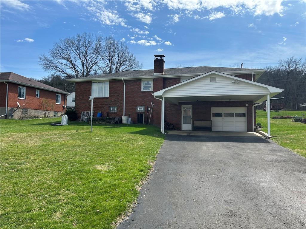 356 3rd Street Smithton, PA 15479 - Photo 3 of 21 a front view of a house with a yard and garage