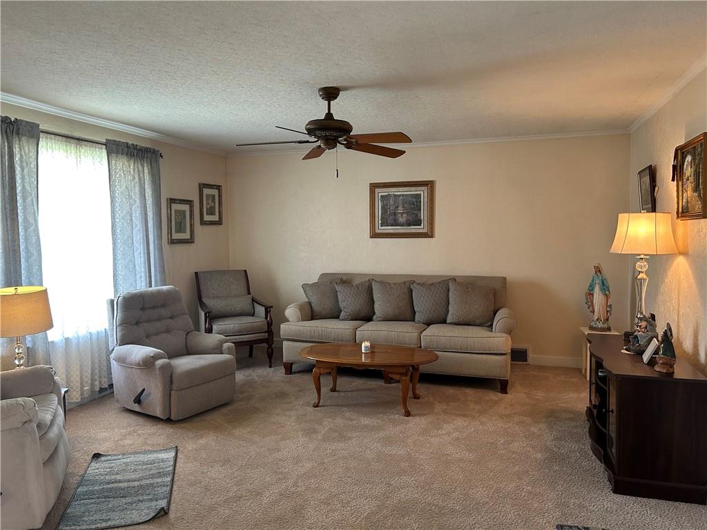356 3rd Street Smithton, PA 15479 - Photo 6 of 21 a living room with furniture and a lamp