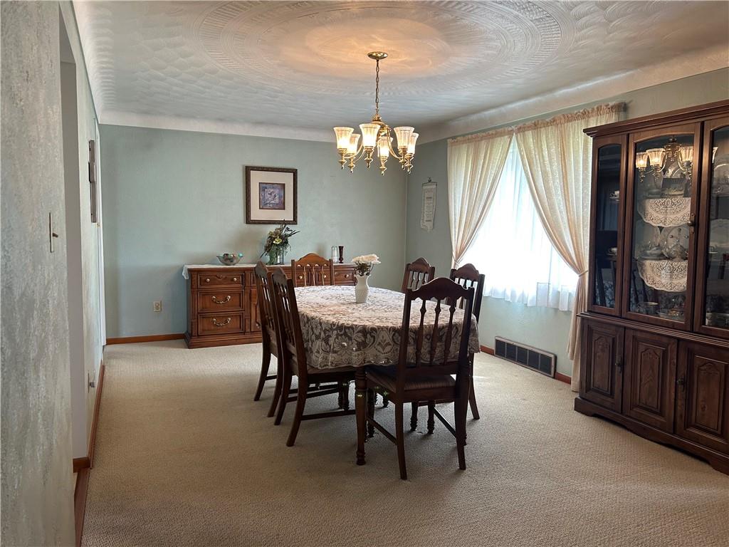 356 3rd Street Smithton, PA 15479 - Photo 9 of 21 a dining room with furniture a chandelier and window