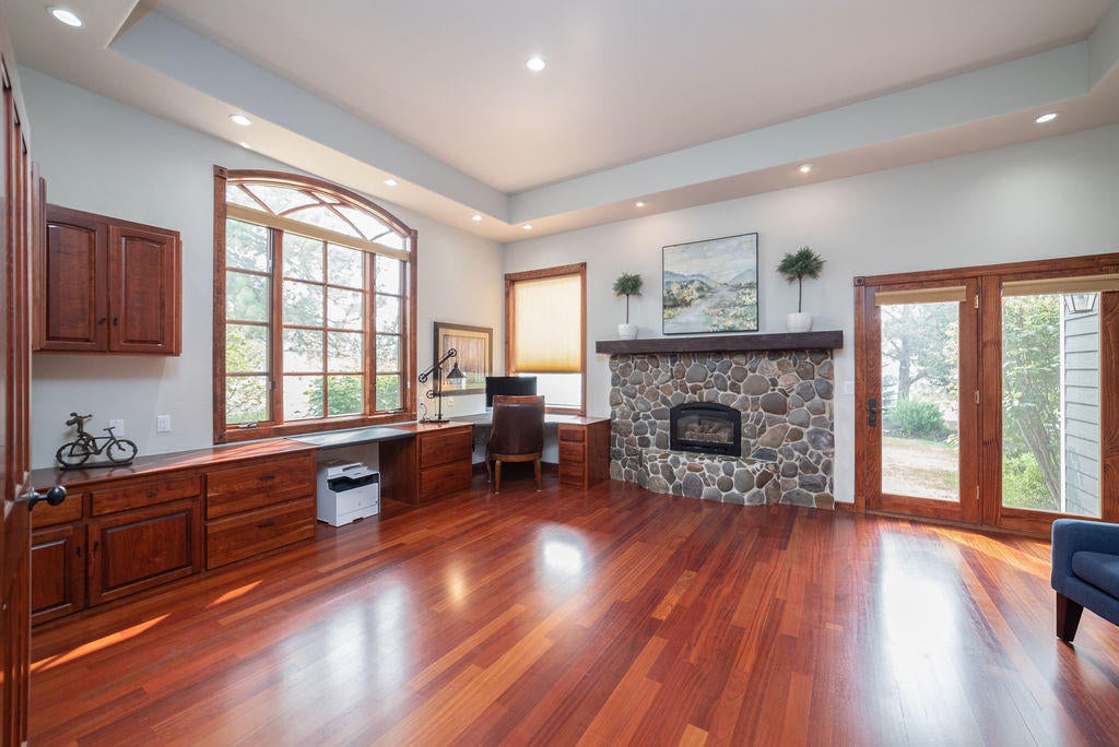 60675 Billadeau Road Bend, OR 97702 - Photo 25 of 87 You can find the 3rd fireplace in the huge office located off the master suite which also has access to the side yard through french doors.