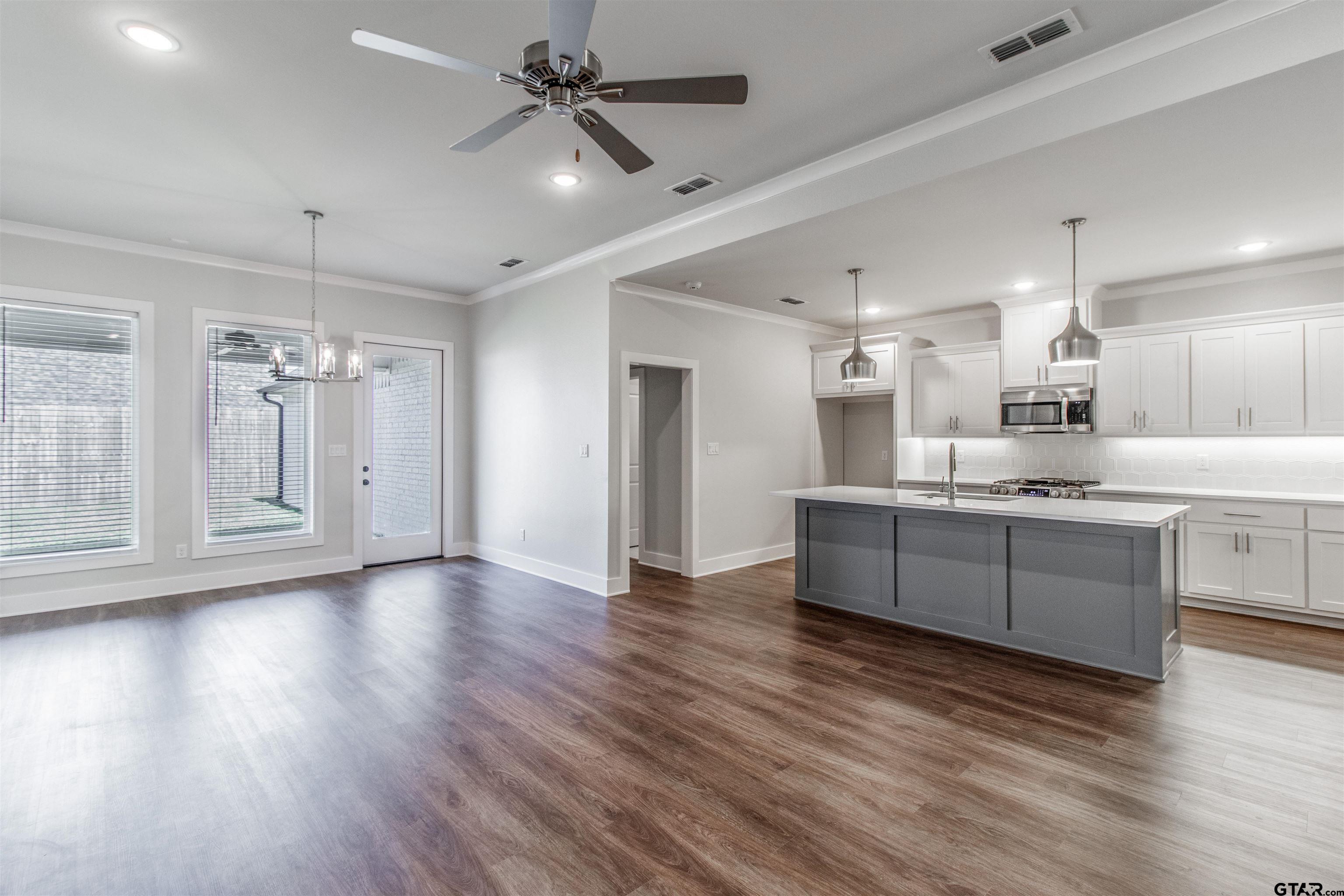 7013 Hillside Avenue Tyler, TX 75707 - Photo 12 of 37 a large kitchen with hardwood floor and a sink