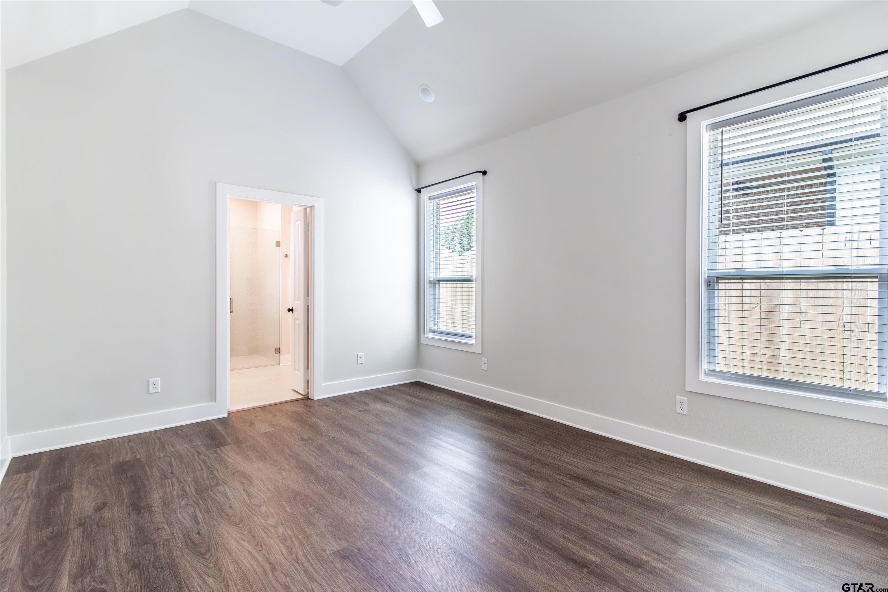 7013 Hillside Avenue Tyler, TX 75707 - Photo 21 of 37 an empty room with wooden floor and windows