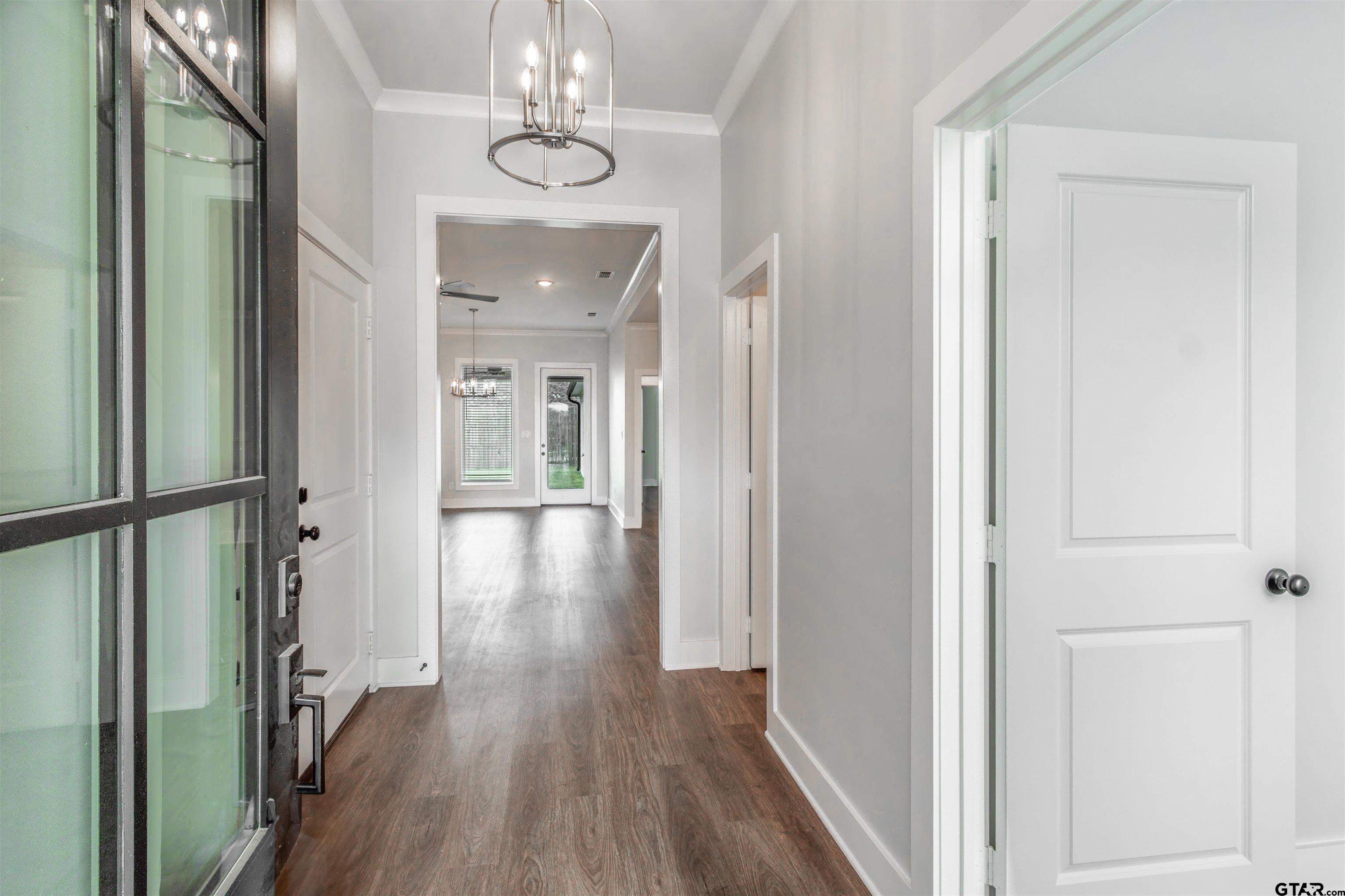 7013 Hillside Avenue Tyler, TX 75707 - Photo 4 of 37 a view of a hallway with wooden floor and staircase