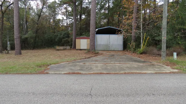 a front view of a house with a yard and tree s