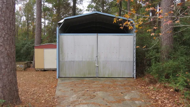 a view of a small house with backyard
