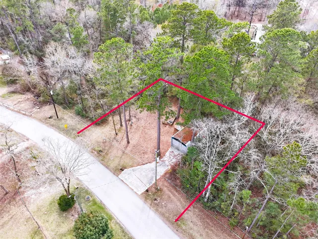 a view of a wooden house with a backyard