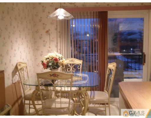 197 Evergreen Road, Unit 7B Edison, NJ 08837 - Photo 4 of 6 a dining room with furniture and wooden floor