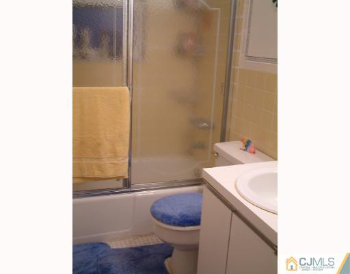 197 Evergreen Road, Unit 7B Edison, NJ 08837 - Photo 5 of 6 a bathroom with a sink and a toilet