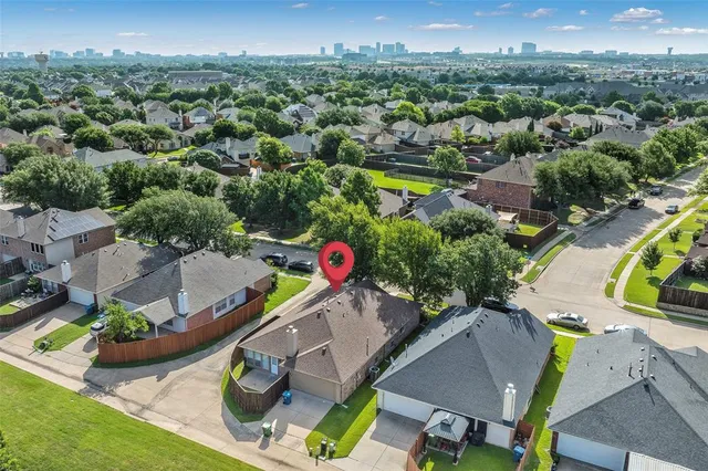 an aerial view of a swimming pool with outdoor seating