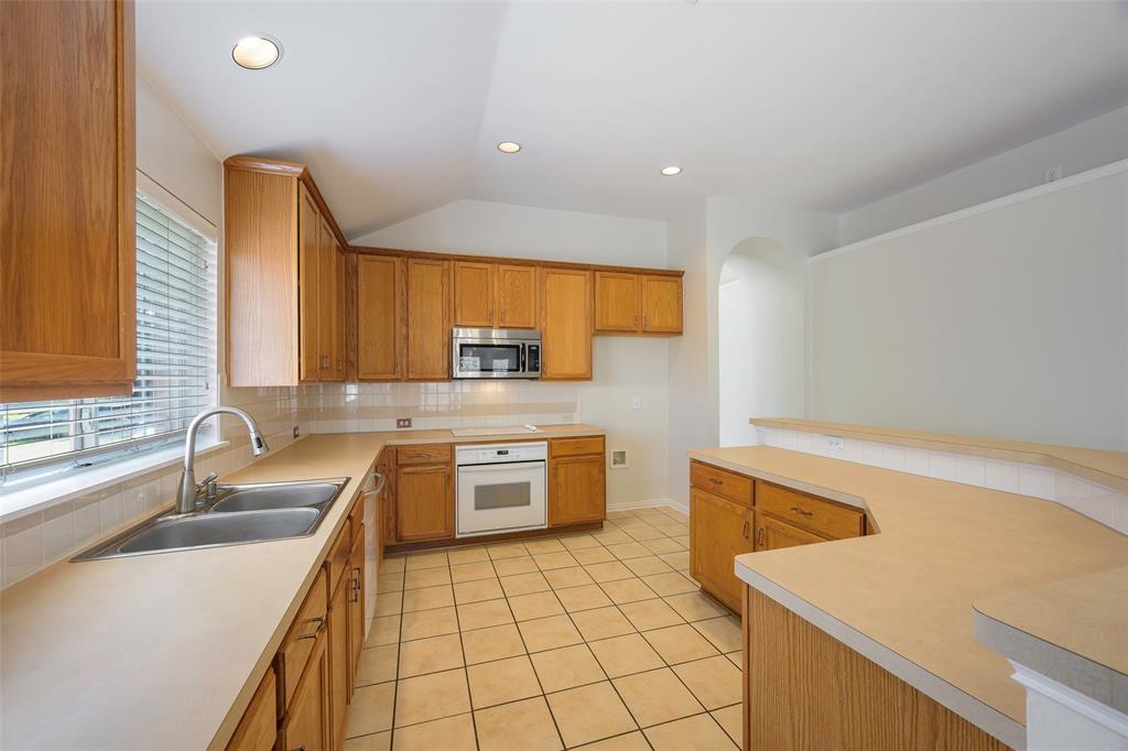 6101 Apache Drive The Colony, TX 75056 - Photo 3 of 24 a kitchen with a sink a stove top oven a counter space and cabinets