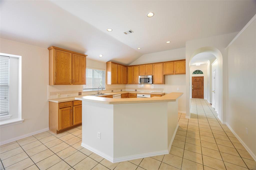 6101 Apache Drive The Colony, TX 75056 - Photo 6 of 24 a large white kitchen with a stove a sink dishwasher and a refrigerator