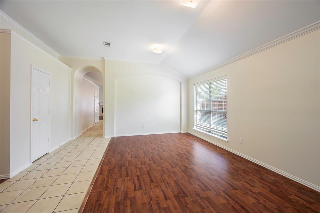 6101 Apache Drive The Colony, TX 75056 - Photo 10 of 24 a view of an empty room with wooden floor and a window