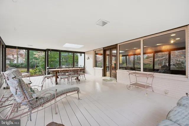 a living room with furniture and large windows