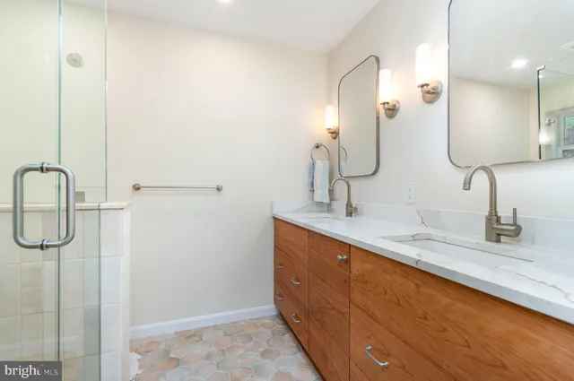 a bathroom with a double vanity sink and mirror
