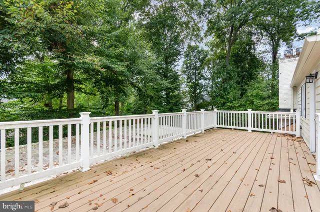a porch with wooden floor and fence