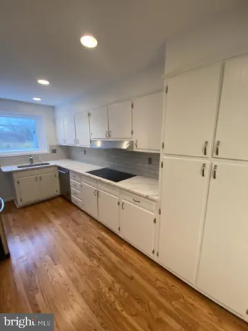 a kitchen with cabinets a sink and appliances