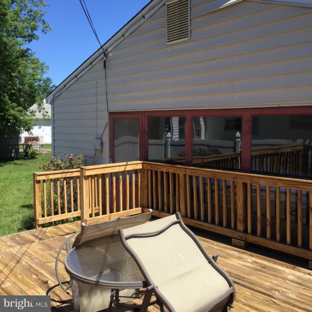 6224 Auth Road Suitland, MD 20746 - Photo 2 of 14 a balcony with wooden floor table and chairs
