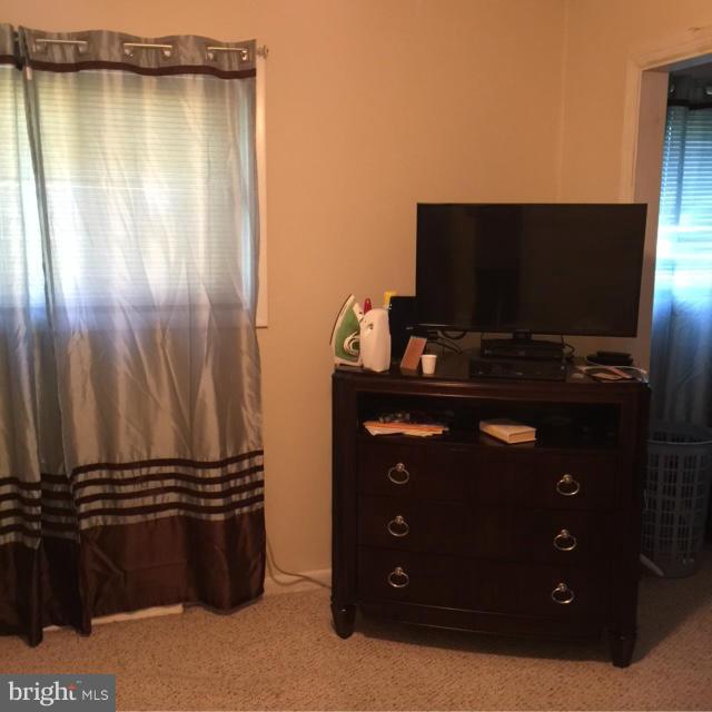 6224 Auth Road Suitland, MD 20746 - Photo 11 of 14 a living room with a flat screen tv and a fireplace