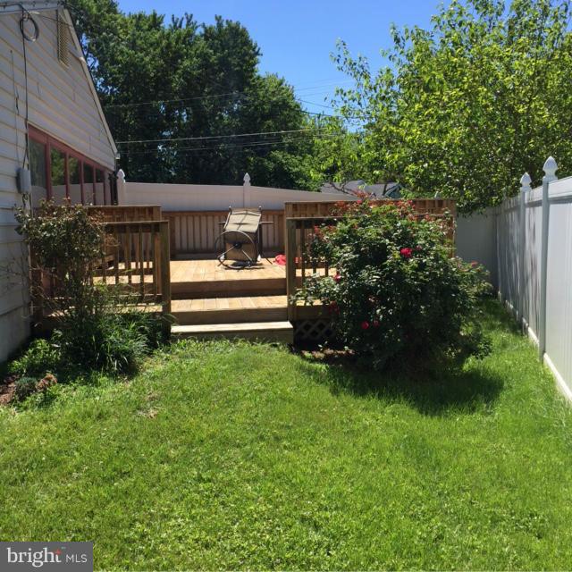 6224 Auth Road Suitland, MD 20746 - Photo 4 of 14 a view of a garden with plants and large trees