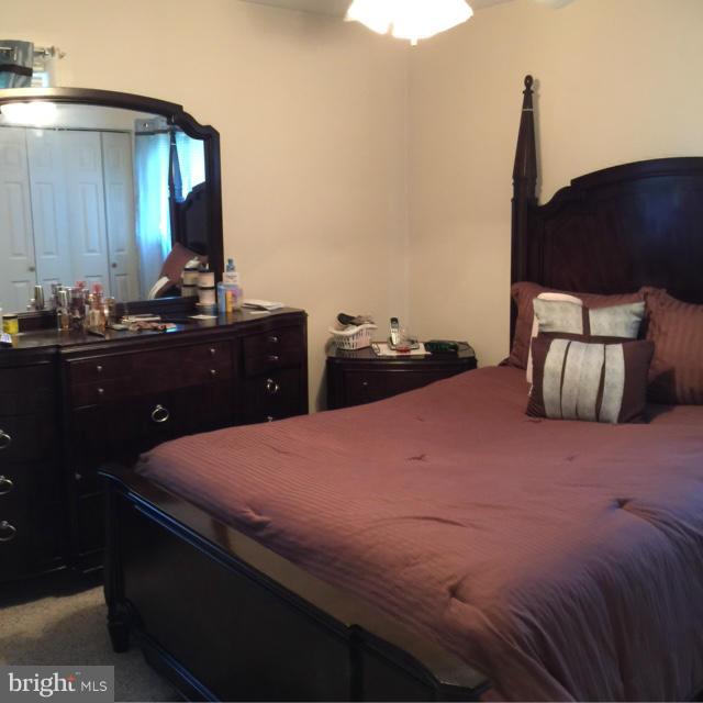 6224 Auth Road Suitland, MD 20746 - Photo 10 of 14 a bedroom with a bed and a dresser