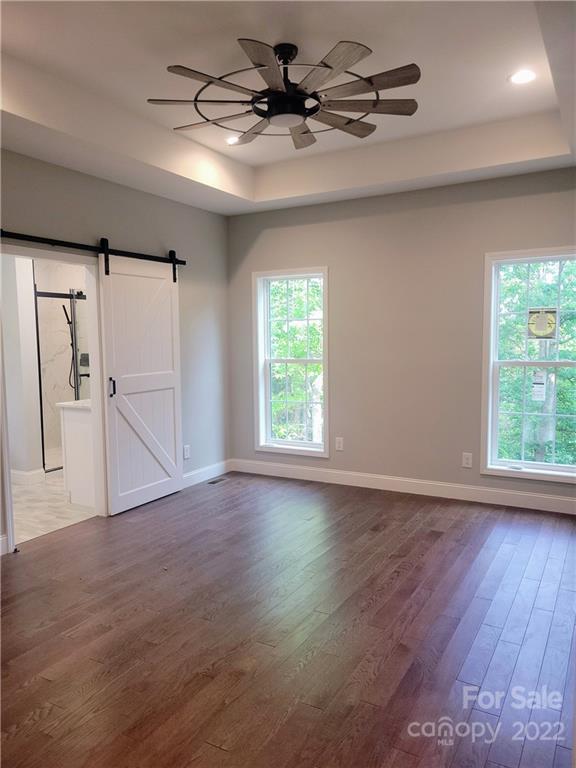 2304 Peniel Road Columbus, NC 28722 - Photo 8 of 18 a view of an empty room with a window and wooden floor