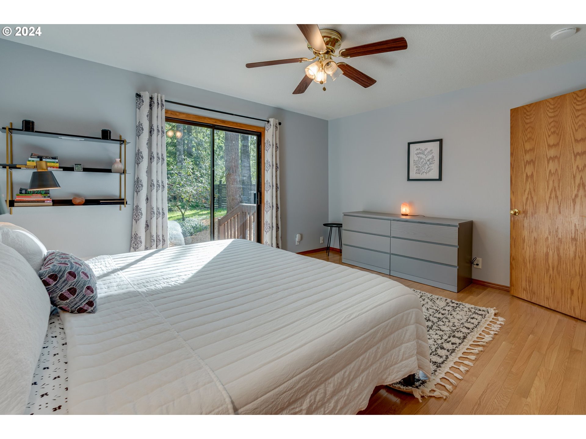 65377 East Sandy River Lane Rhododendron, OR 97049 - Photo 12 of 40 a bedroom with a bed and a chandelier