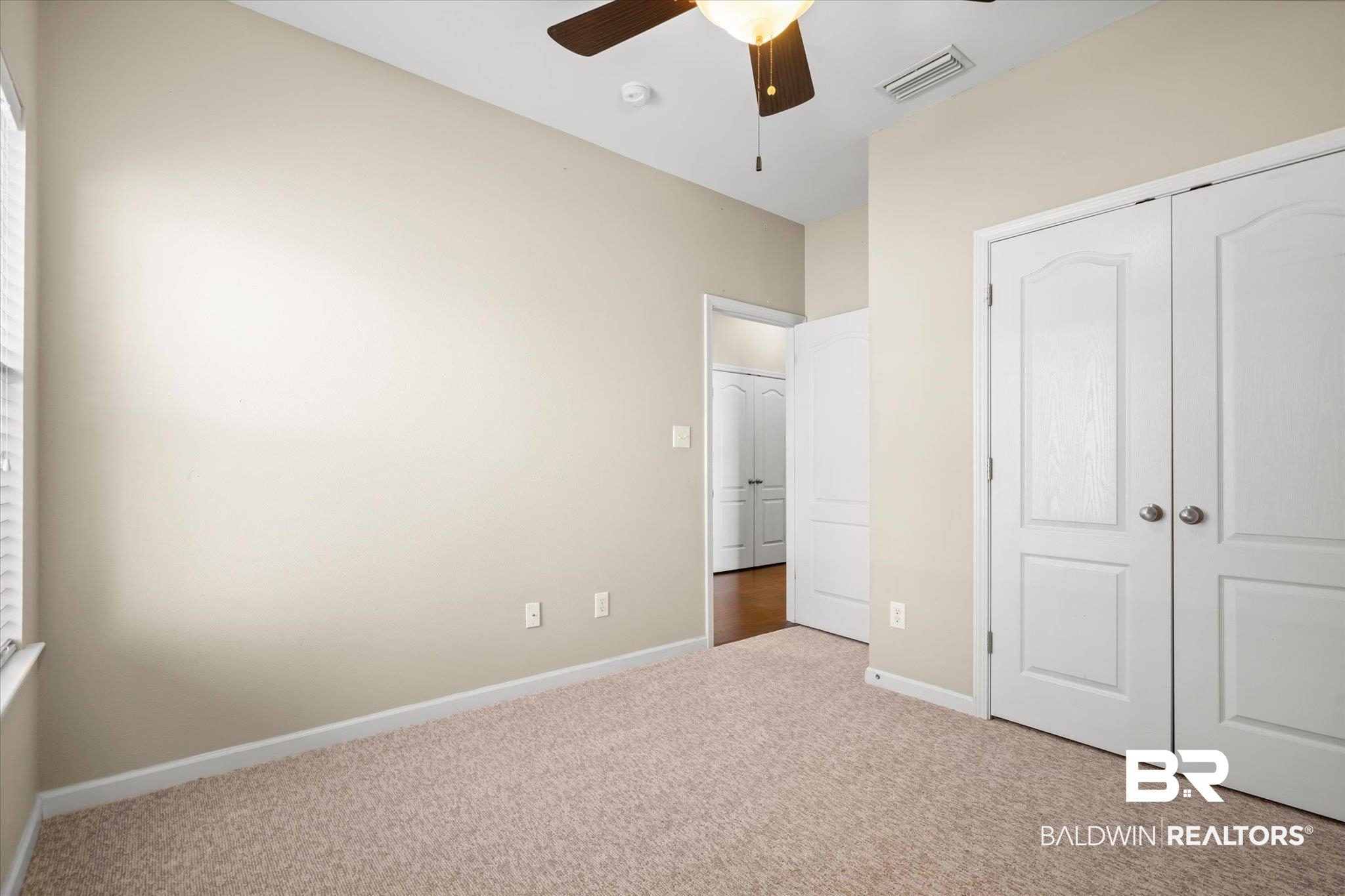 10251 Fionn Loop Daphne, AL 36526 - Photo 15 of 28 Unfurnished bedroom with a closet, light colored carpet, and ceiling fan