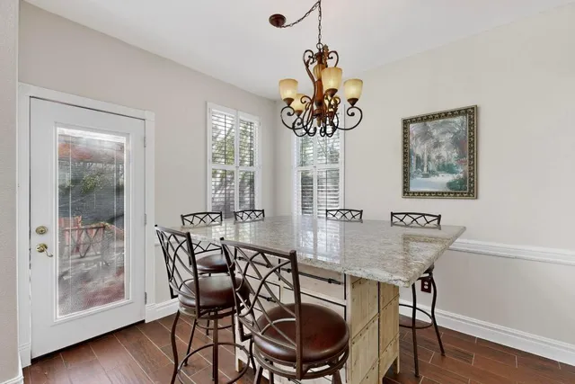 a view of a dining room with furniture wooden floor and chandelier