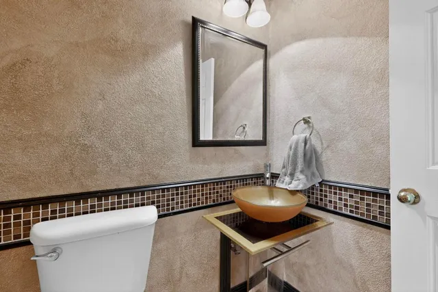 a living room with furniture and a mirror