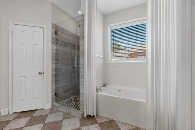 a bathroom with a bathtub and shower