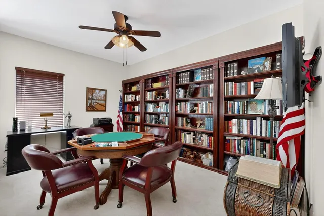 a dining room with furniture and a book shelf