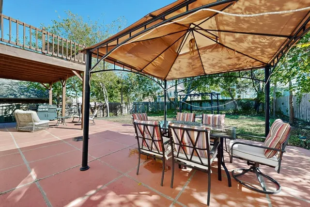 a patio with a patio table and chairs