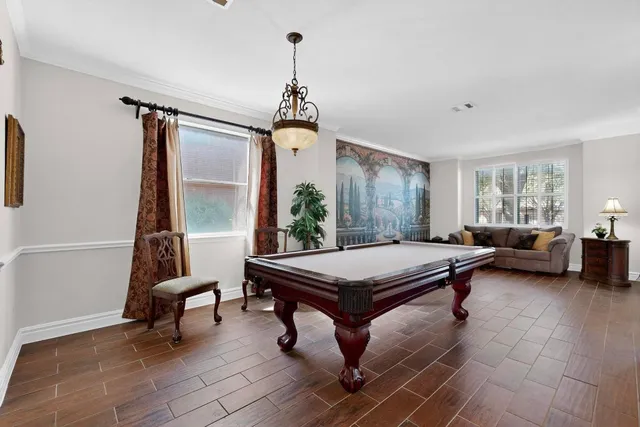 a living room with furniture a window and a chandelier