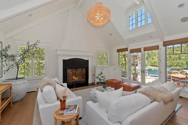a living room with furniture a fireplace and a large window