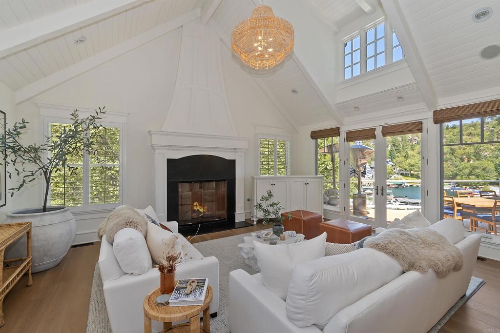 a living room with furniture a fireplace and a large window