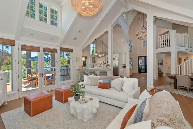 a living room with a table chairs and wooden floor