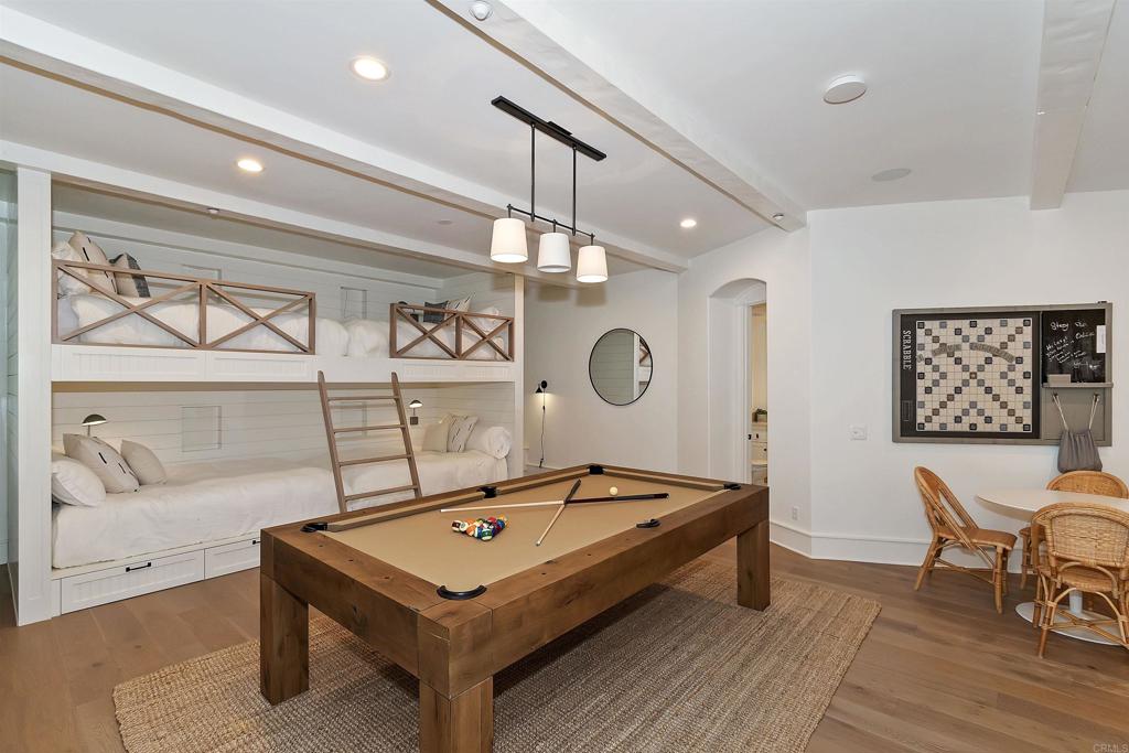 27567 West Shore Road Lake Arrowhead, CA 92352 - Photo 20 of 62 a living room with a table chairs and wooden floor