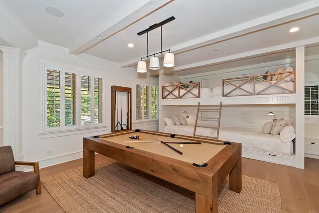 a bedroom with a large bed and a chandelier