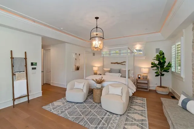 a bedroom with a bed and a chandelier