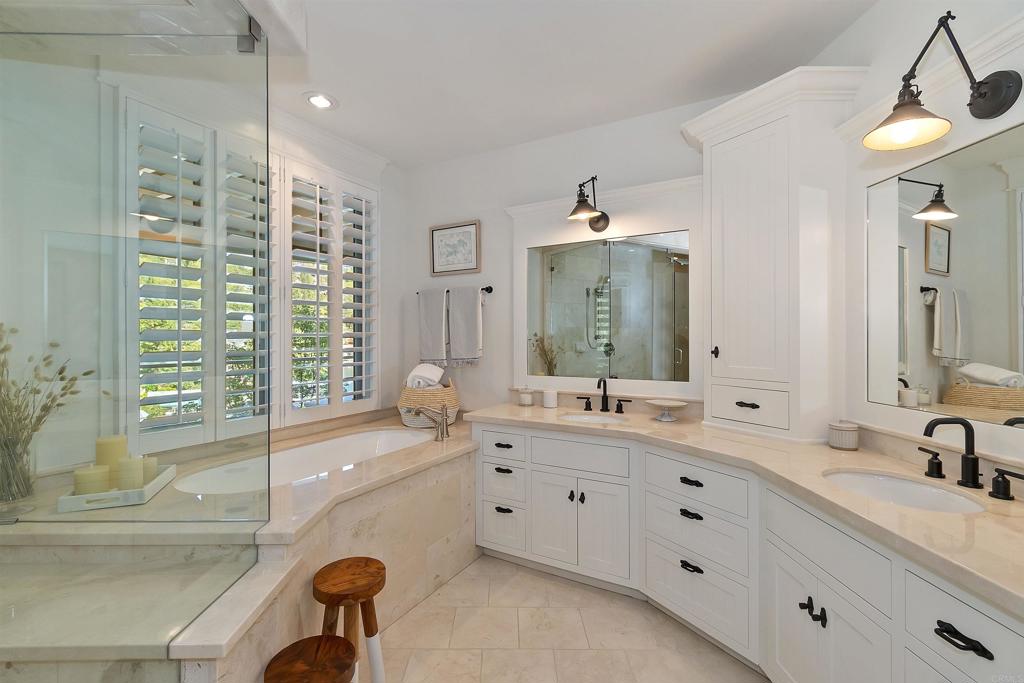 27567 West Shore Road Lake Arrowhead, CA 92352 - Photo 30 of 62 a bathroom with a double vanity sink a mirror a bathtub and next to a window