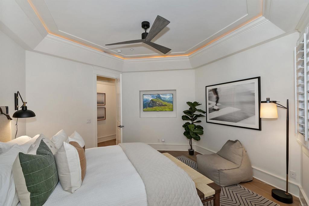 27567 West Shore Road Lake Arrowhead, CA 92352 - Photo 32 of 62 a bedroom with a bed and a chandelier