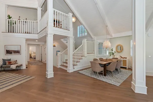 an aerial view of a house with balcony and trees al around