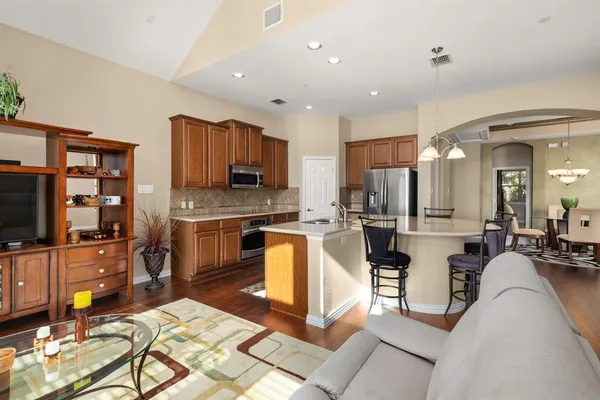 a dining room with furniture and wooden floor