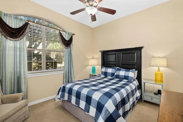a bedroom with a bed and a potted plant