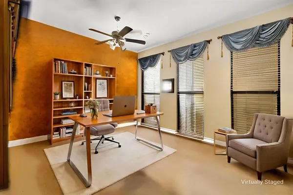 a living room with furniture a chandelier and a window