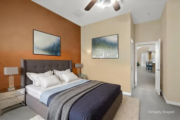 a bedroom with bed and a chandelier